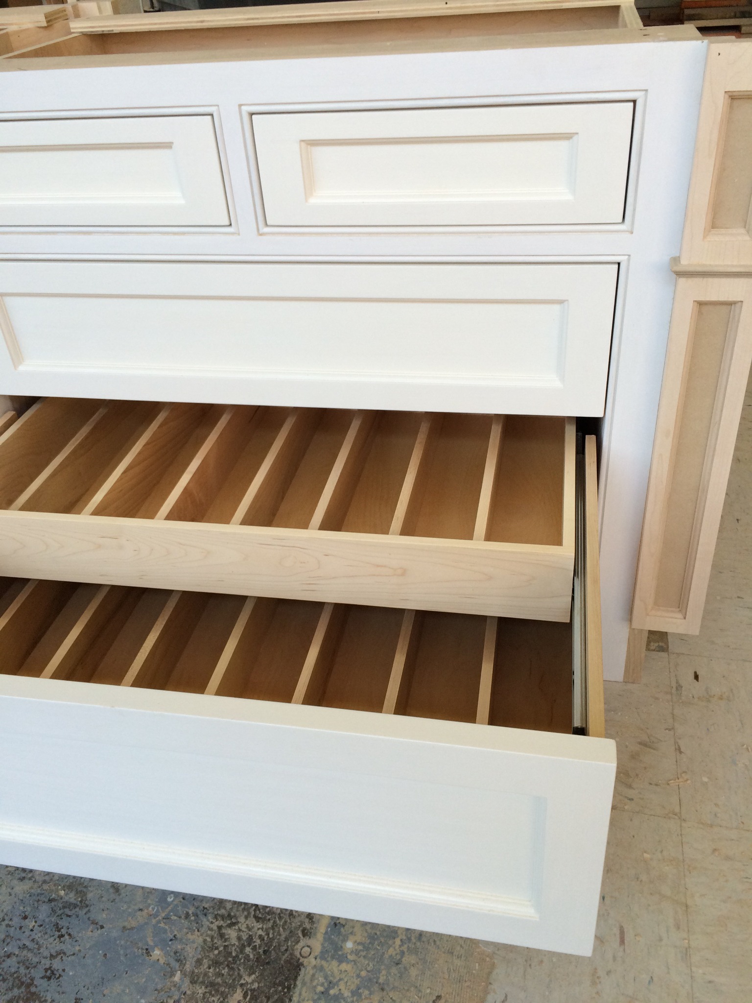 Close detail of handcrafted cabinet drawers with fitted dividers